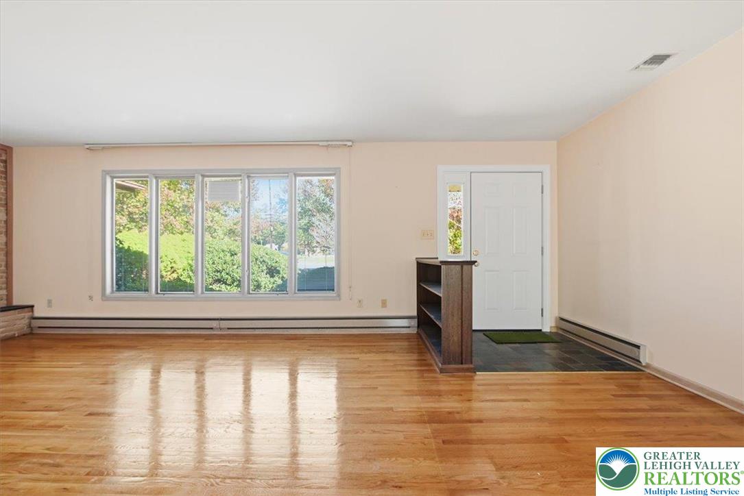 4395 East Texas Road Allentown, PA 18103 - Photo 18 of 81 a view of empty room with wooden floor and fan