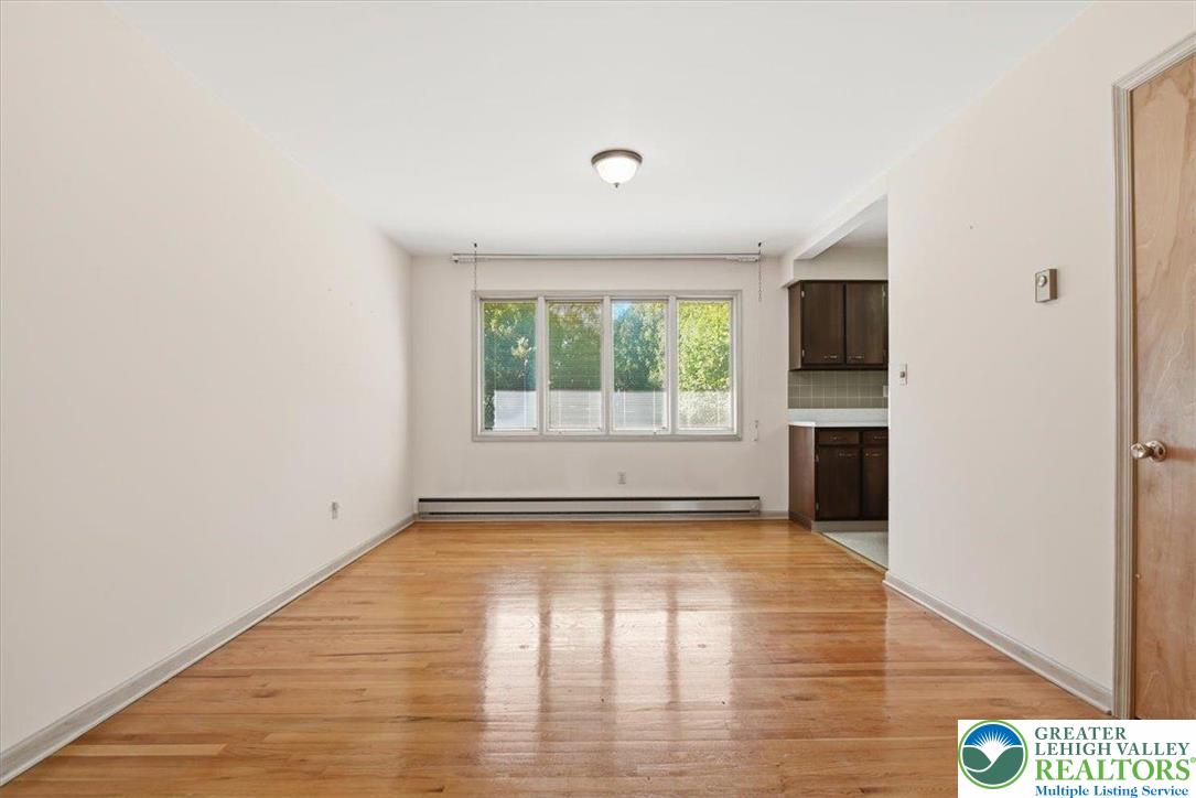 4395 East Texas Road Allentown, PA 18103 - Photo 19 of 81 a view of an empty room with a window and wooden floor