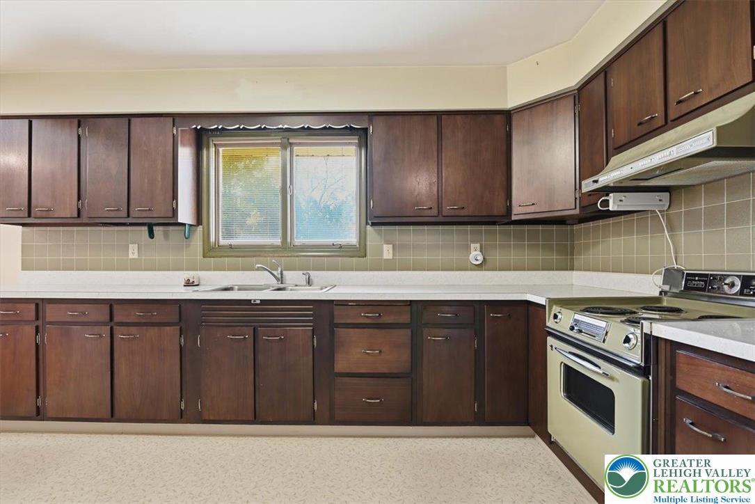 4395 East Texas Road Allentown, PA 18103 - Photo 28 of 81 a kitchen with stainless steel appliances granite countertop a sink stove and cabinets