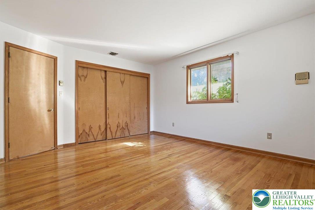 4395 East Texas Road Allentown, PA 18103 - Photo 40 of 81 a view of an empty room with wooden floor and a window