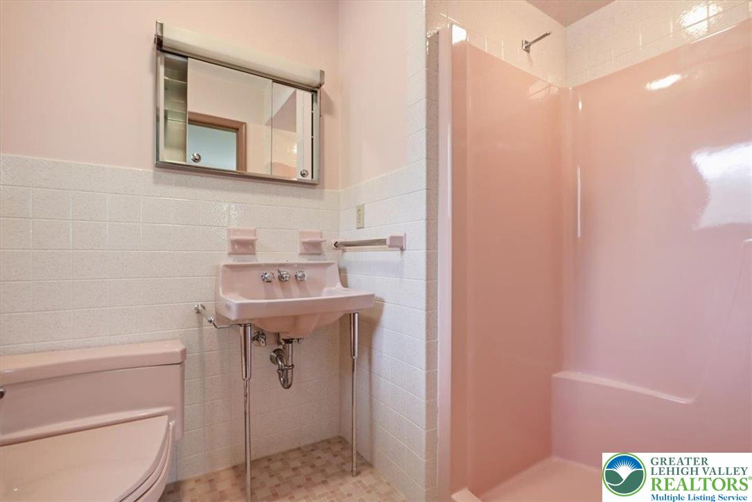 4395 East Texas Road Allentown, PA 18103 - Photo 43 of 81 a bathroom with a sink a mirror and a toilet