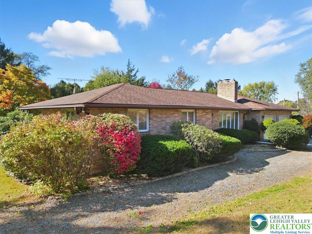 4395 East Texas Road Allentown, PA 18103 - Photo 8 of 81 a front view of a house with a yard and fountain in middle