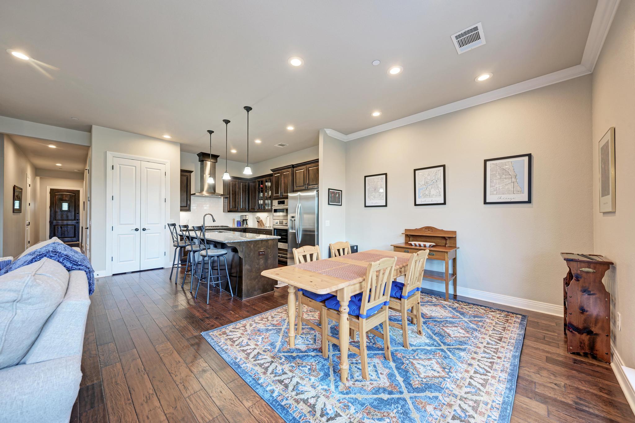 2601 North Quinlan Park Road, Unit 506 Austin, TX 78732 - Photo 21 of 39 Rich hardwood flooring extends through this open-concept living space, uniting the kitchen and dining area.