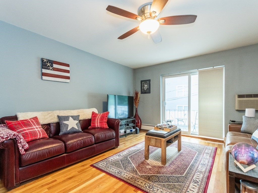 48 Coffey Street, Unit 5B Boston, MA 02122 - Photo 1 of 31 a living room with furniture a rug and a window