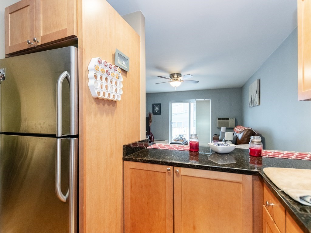 48 Coffey Street, Unit 5B Boston, MA 02122 - Photo 11 of 31 a kitchen with stainless steel appliances granite countertop a refrigerator sink and cabinets
