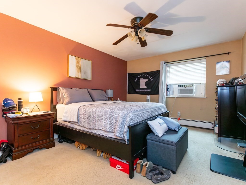 48 Coffey Street, Unit 5B Boston, MA 02122 - Photo 14 of 31 a bedroom with a bed couch and a flat screen tv