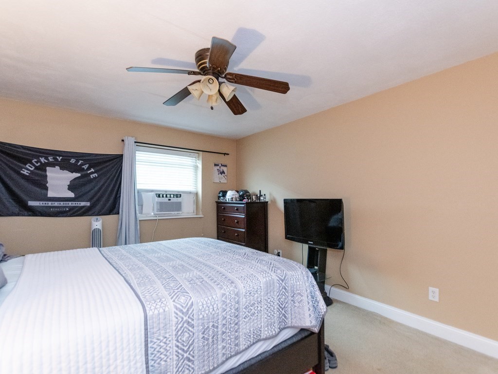 48 Coffey Street, Unit 5B Boston, MA 02122 - Photo 15 of 31 a bedroom with a bed and a tv
