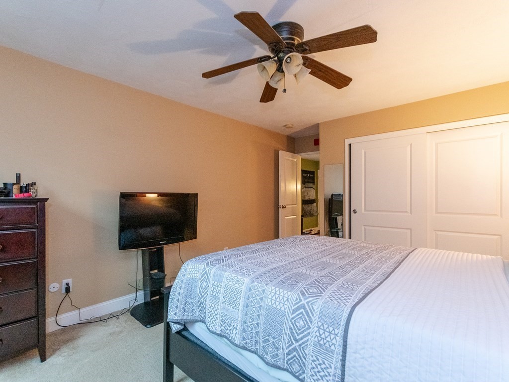 48 Coffey Street, Unit 5B Boston, MA 02122 - Photo 17 of 31 a bedroom with a bed and a flat screen tv