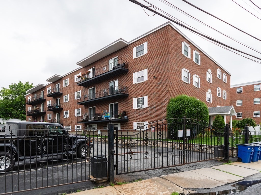 48 Coffey Street, Unit 5B Boston, MA 02122 - Photo 24 of 31 a front view of a building with glass windows