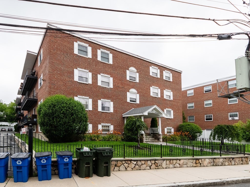 48 Coffey Street, Unit 5B Boston, MA 02122 - Photo 25 of 31 a view of a brick building next to a yard