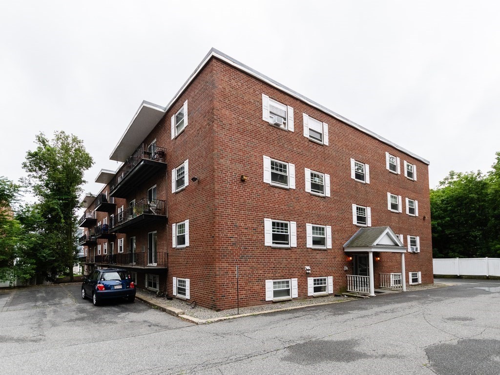 48 Coffey Street, Unit 5B Boston, MA 02122 - Photo 27 of 31 a front view of a building with parking space