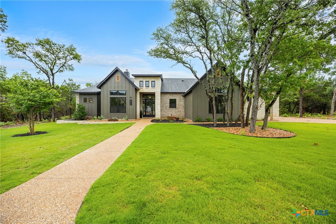 a front view of house with yard and green space