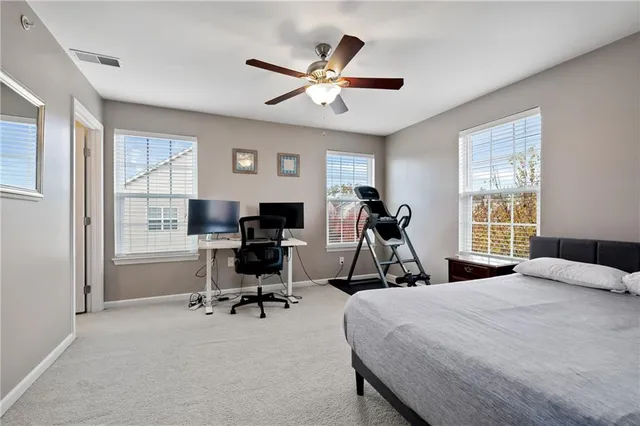 a bedroom with a bed and a large window