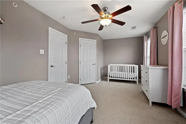 a spacious bedroom with a bed and a window