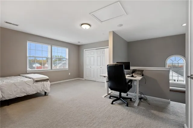 a view of a workspace with furniture and a window