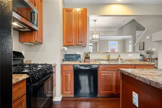 a kitchen with stainless steel appliances granite countertop a stove and a sink