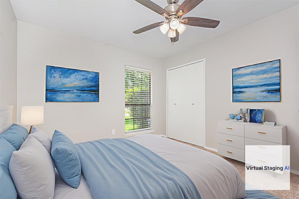 5549 Ragan Drive The Colony, TX 75056 - Photo 14 of 22 a bedroom with a bed and a chandelier