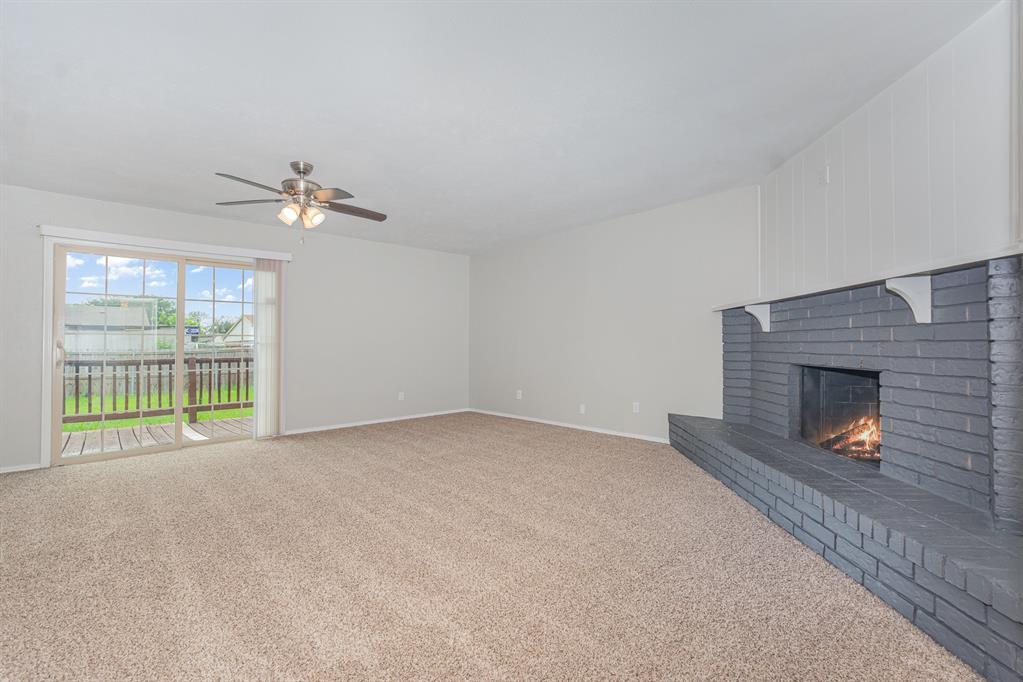 5549 Ragan Drive The Colony, TX 75056 - Photo 4 of 22 a view of an empty room with a fireplace