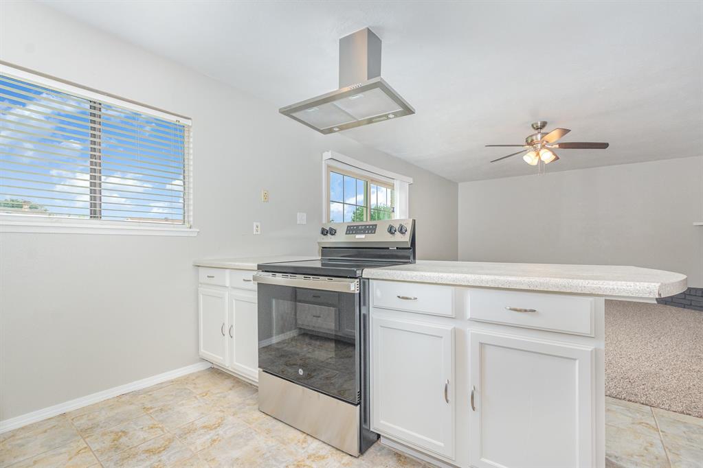 5549 Ragan Drive The Colony, TX 75056 - Photo 5 of 22 a kitchen with white cabinets appliances and a window