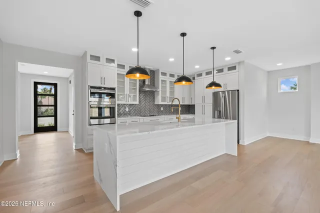 a bedroom with a bed a large window and a flat screen tv