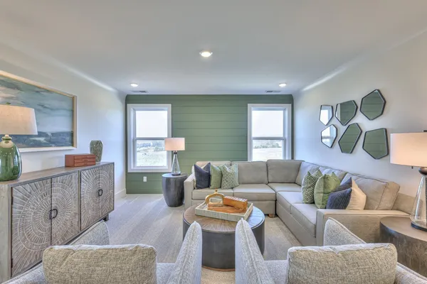 a living room with furniture and a wooden floor