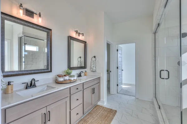 a spacious bathroom with a granite countertop sink mirror and double