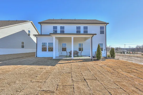 a view of a brick house with a yard