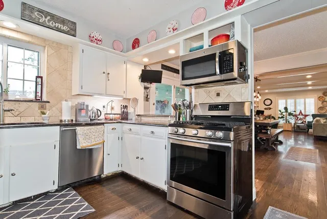 a kitchen with stainless steel appliances granite countertop a stove and a sink
