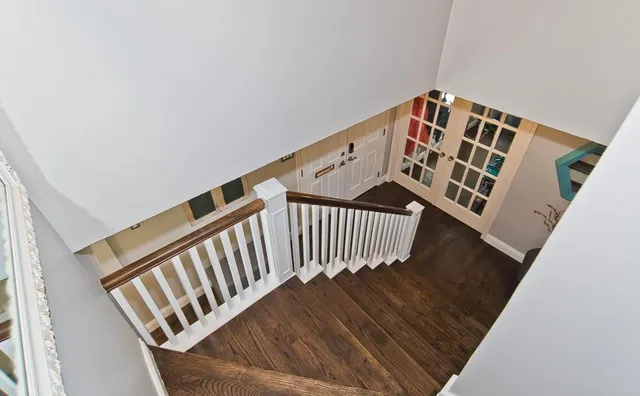 a view of staircase with white walls and a window