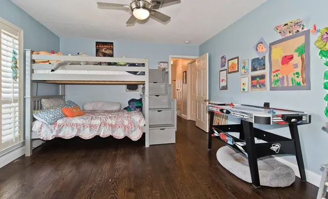 a bed room with a bed mirror and a window