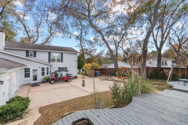 a view of a house with a yard and tree s