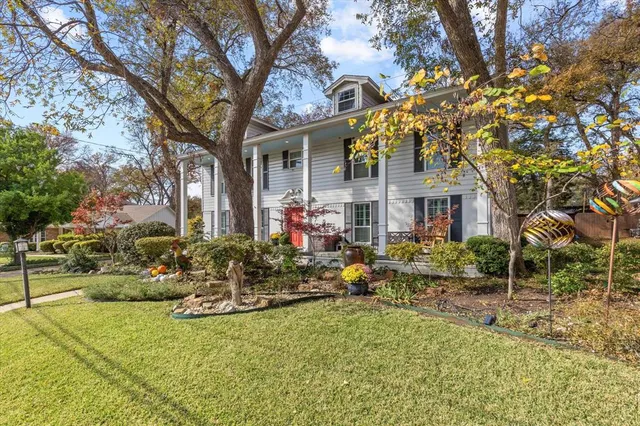 a front view of house with yard and green space