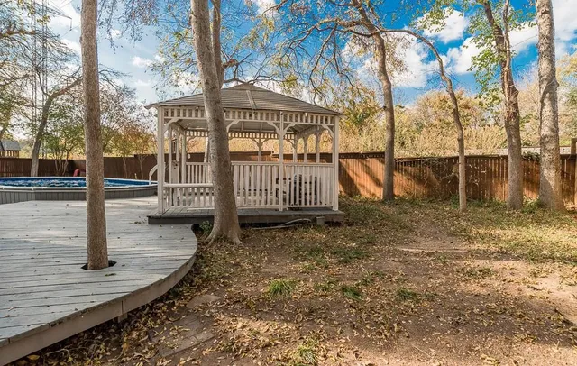 a view of a park with large trees