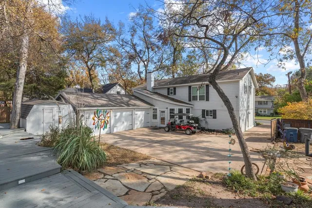 a white house that has a tree in front of it