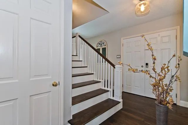 a view of entryway with wooden floor and stairs