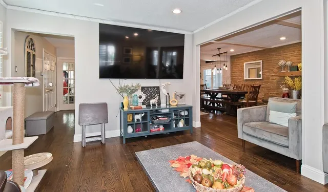 a living room with furniture and wooden floor