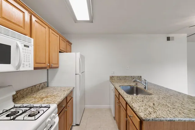 a kitchen that has a sink and a stove