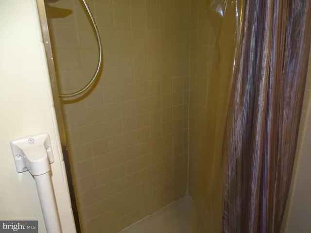 a bathroom with a mirror and a shower