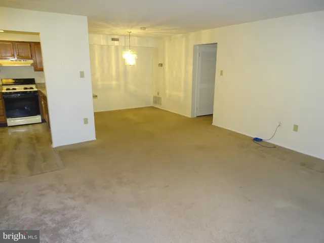 a view of a big room with windows and wardrobe