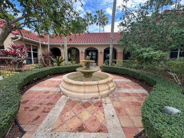 2103 Renaissance Boulevard, Unit 307 Miramar, FL 33025 - Photo 21 of 25 a front view of a house with garden