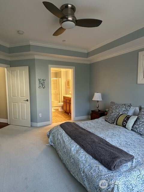 23943 Northeast 115th Lane, Unit 204 Redmond, WA 98053 - Photo 10 of 24 a bedroom with a bed and a chandelier