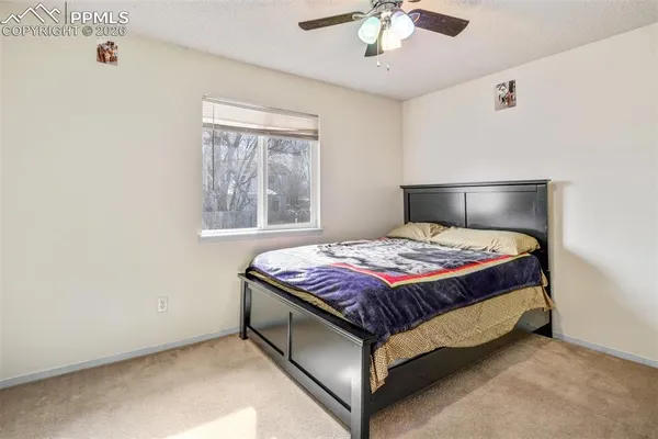 a bed sitting in a bedroom next to a window
