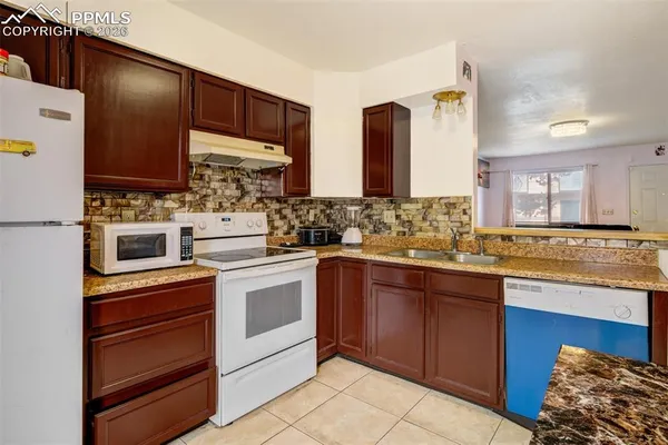 a kitchen with stainless steel appliances granite countertop a sink and cabinets