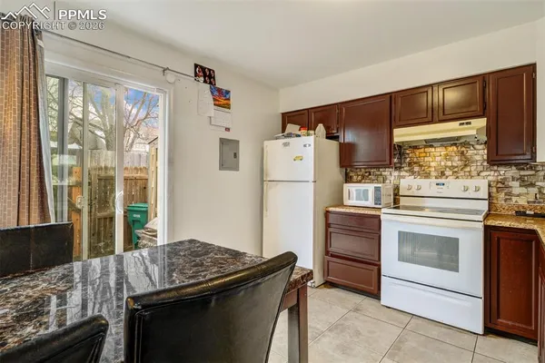 a kitchen with a refrigerator stove and sink