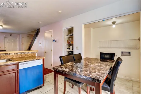 a kitchen with a stove and chairs