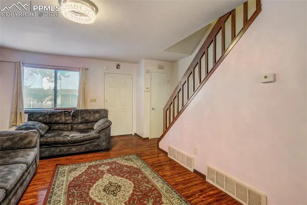 a living room with furniture and a rug