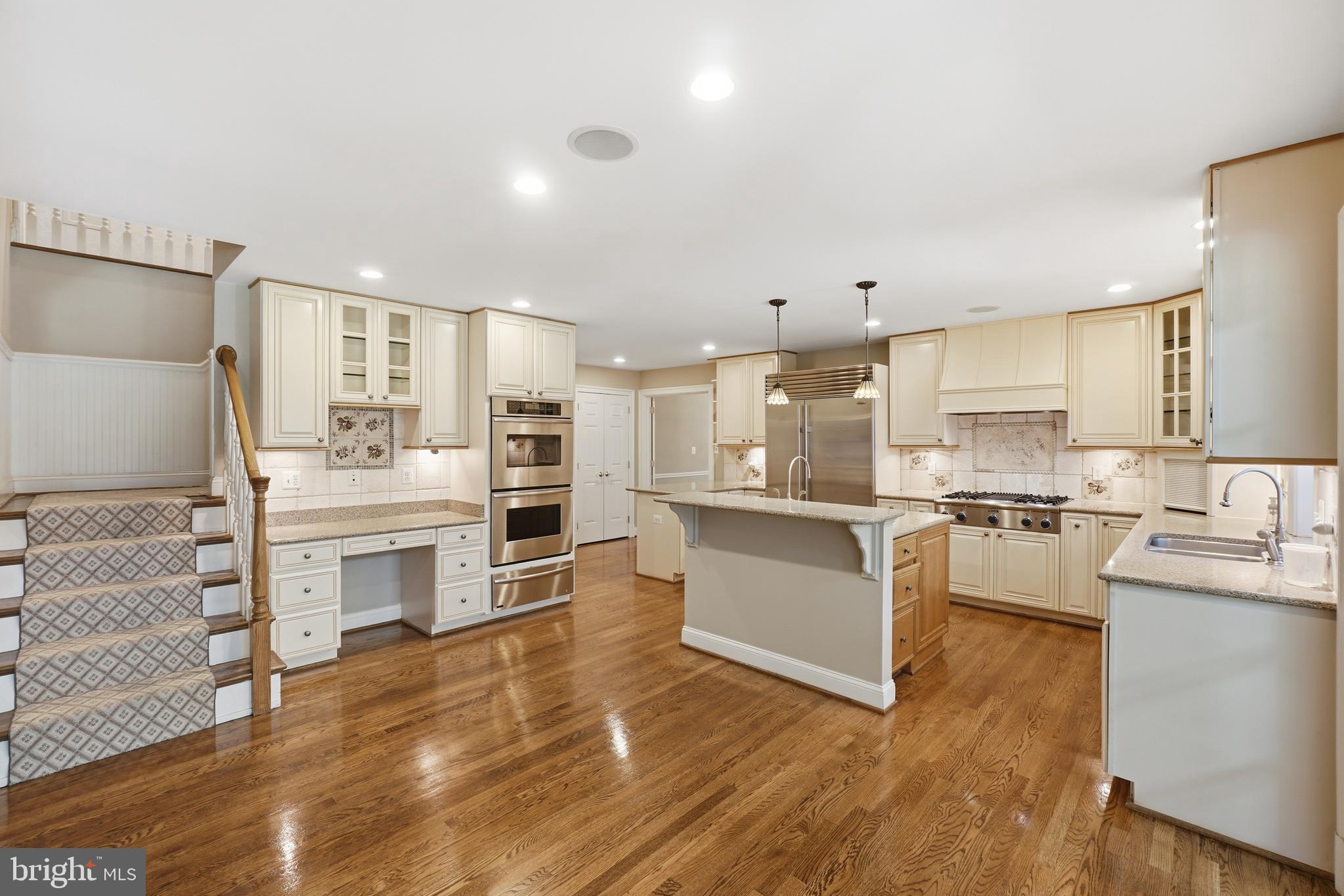 9904 Hall Road Potomac, MD 20854 - Photo 4 of 37 a large kitchen with kitchen island a counter top space a sink stainless steel appliances and cabinets