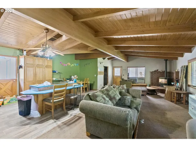 a living room with furniture a flat screen tv and a large window