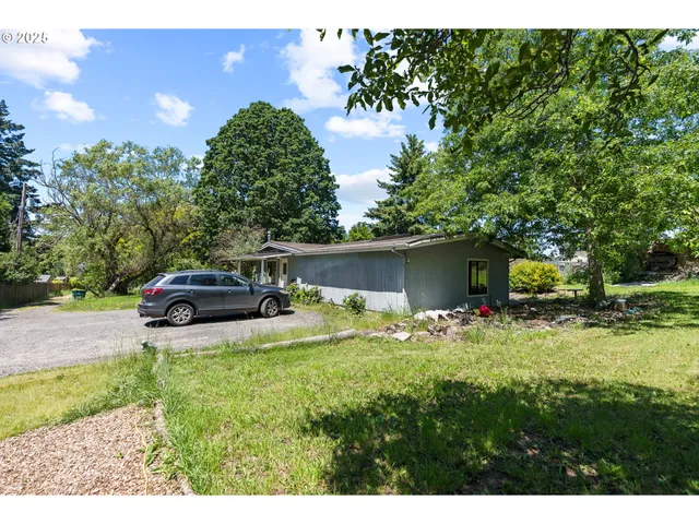 a car parked in front of yellow house