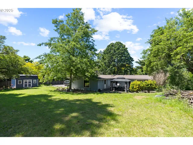 a view of an house with swimming pool and yard